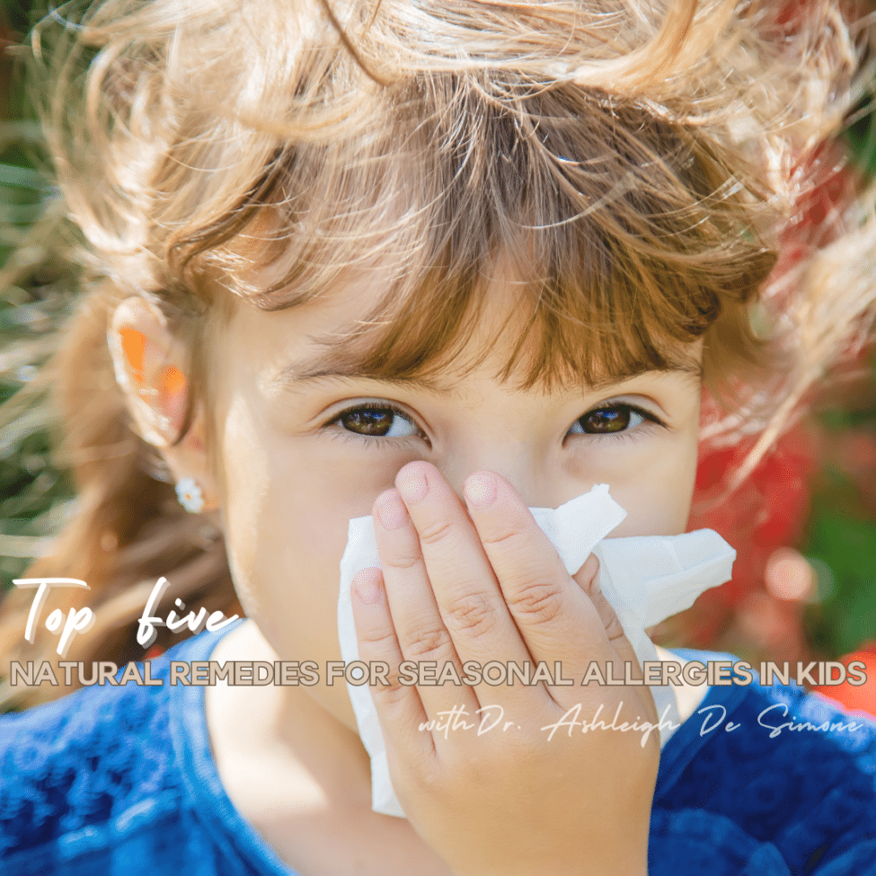 young girl blowing her nose
